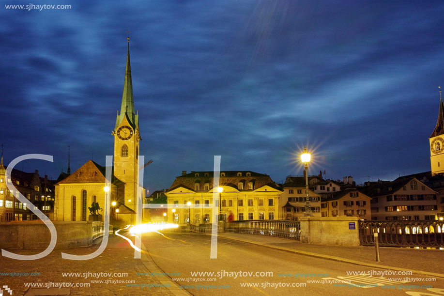 Night photo of Fraumunster Church and bridge over Limmat River, city of Zurich, Switzerland