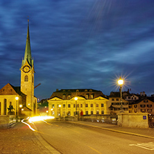 Night photo of Fraumunster Church and bridge over Limmat River, city of Zurich, Switzerland