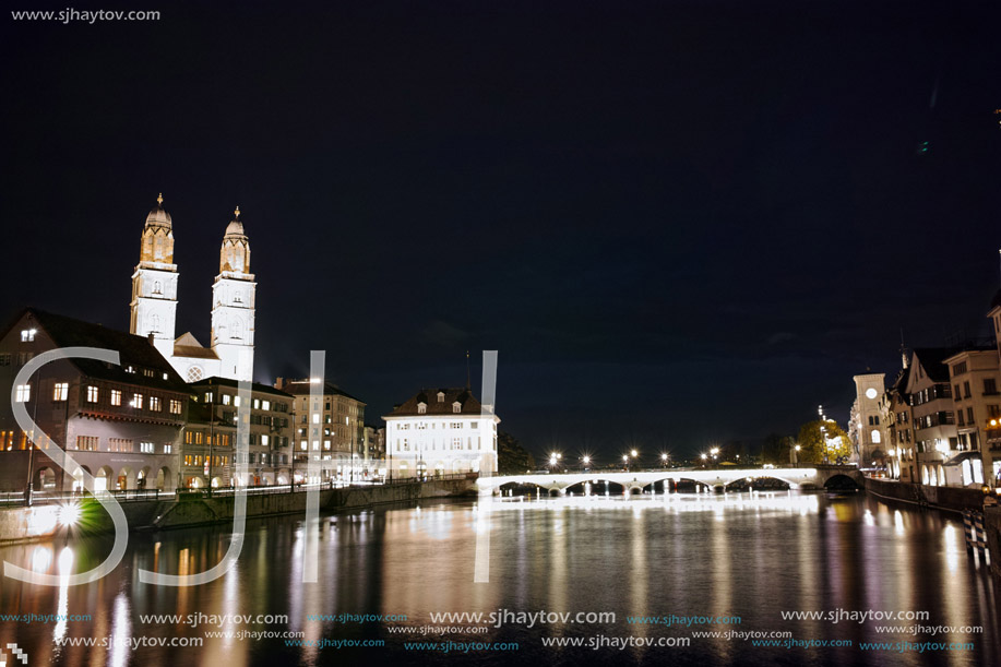 Night panoramic photo of city of Zurich and reflection in Limmat River, Switzerland