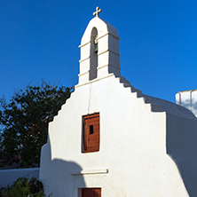 White orthodox church and small bell tower in Mykonos, Cyclades Islands, Greece