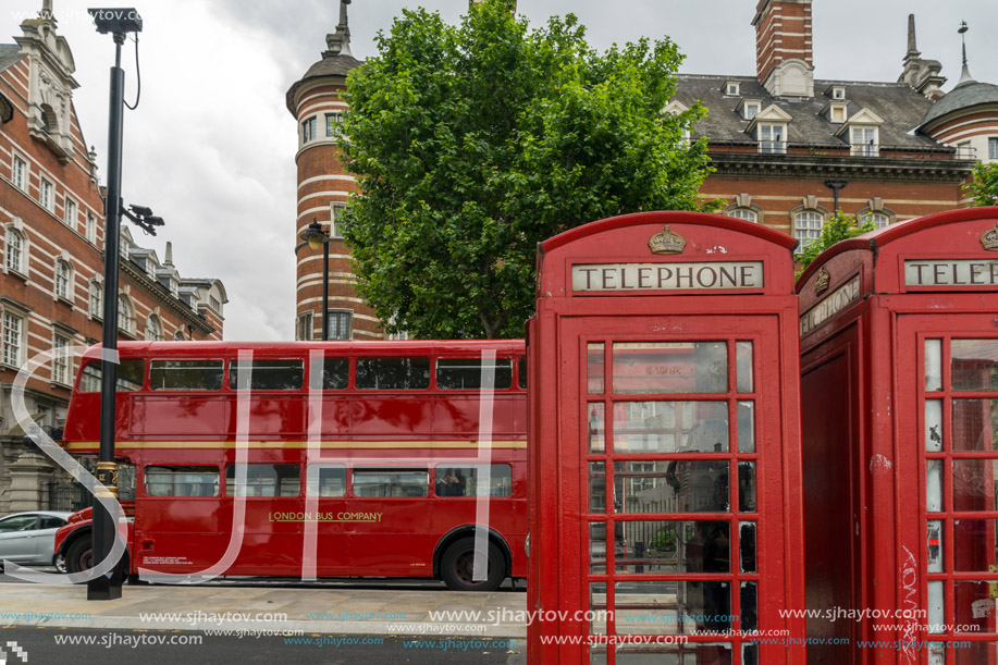 LONDON, ENGLAND - JUNE 16 2016: Phone booth and Red Bus on Westminster, London, England, Great Britain