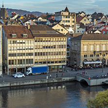 ZURICH, SWITZERLAND - OCTOBER 28, 2015: Reflection of City of Zurich in Limmat River, Switzerland