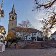 ZURICH, SWITZERLAND - OCTOBER 28, 2015:  St. Peter Church and autumn trees, City of Zurich, Switzerland