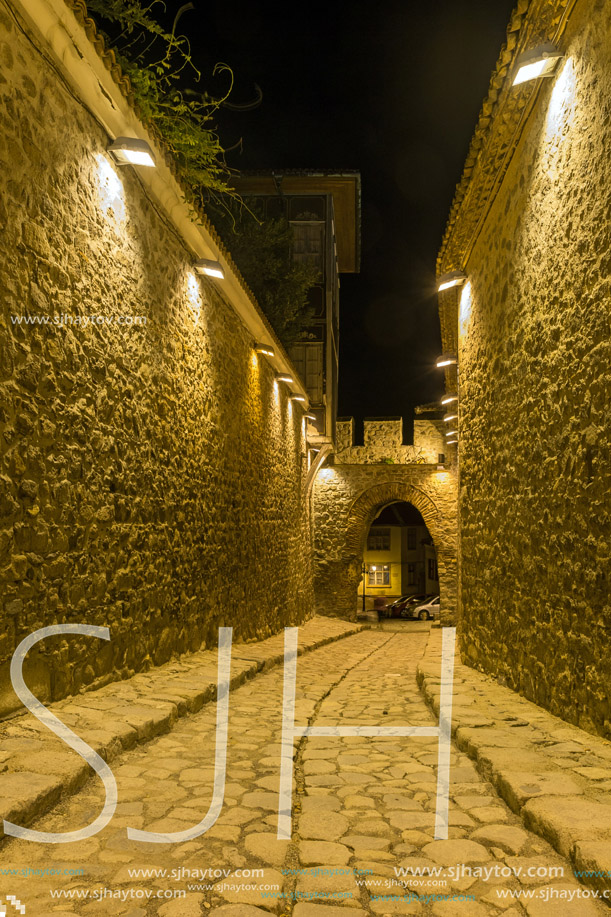 PLOVDIV, BULGARIA - SEPTEMBER 2 2016:  Night photo of Cobblestone street under ancient fortress entrance of old town of city of Plovdiv, Bulgaria