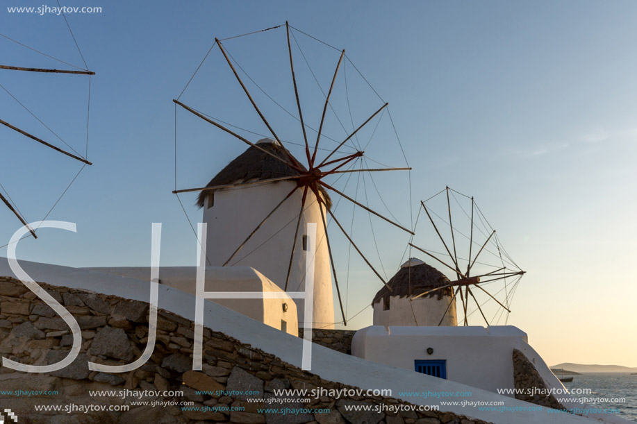 Sunset of White windmills and Aegean sea on the island of Mykonos, Cyclades, Greece