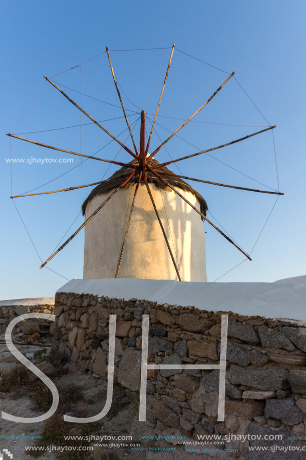 Sunset of White windmills and Aegean sea on the island of Mykonos, Cyclades, Greece