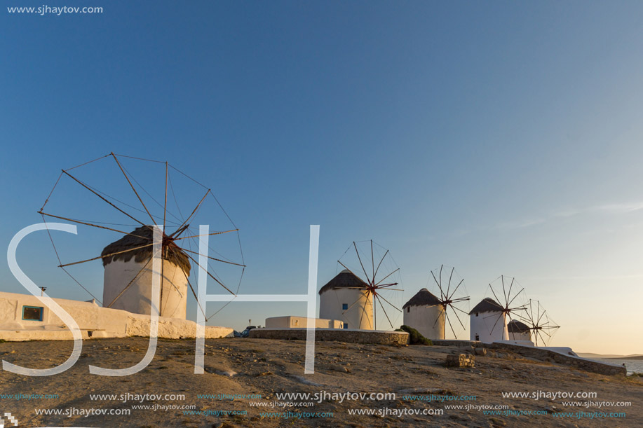 Sunset of White windmills and Aegean sea on the island of Mykonos, Cyclades, Greece