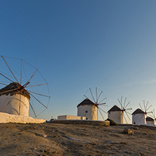 Sunset of White windmills and Aegean sea on the island of Mykonos, Cyclades, Greece