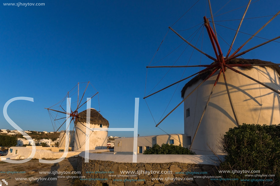 Sunset of White windmills and Aegean sea on the island of Mykonos, Cyclades, Greece