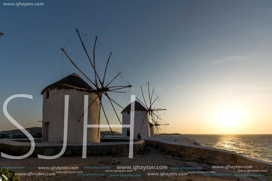 Sunset of White windmills and Aegean sea on the island of Mykonos, Cyclades, Greece