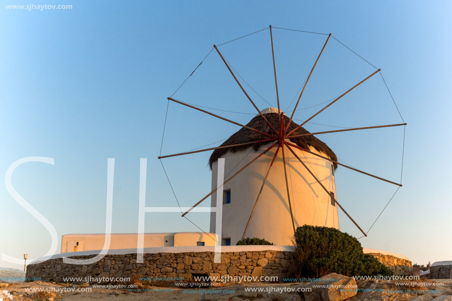 Sunset of White windmills and Aegean sea on the island of Mykonos, Cyclades, Greece