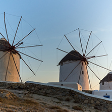 Sunset of White windmills and Aegean sea on the island of Mykonos, Cyclades, Greece