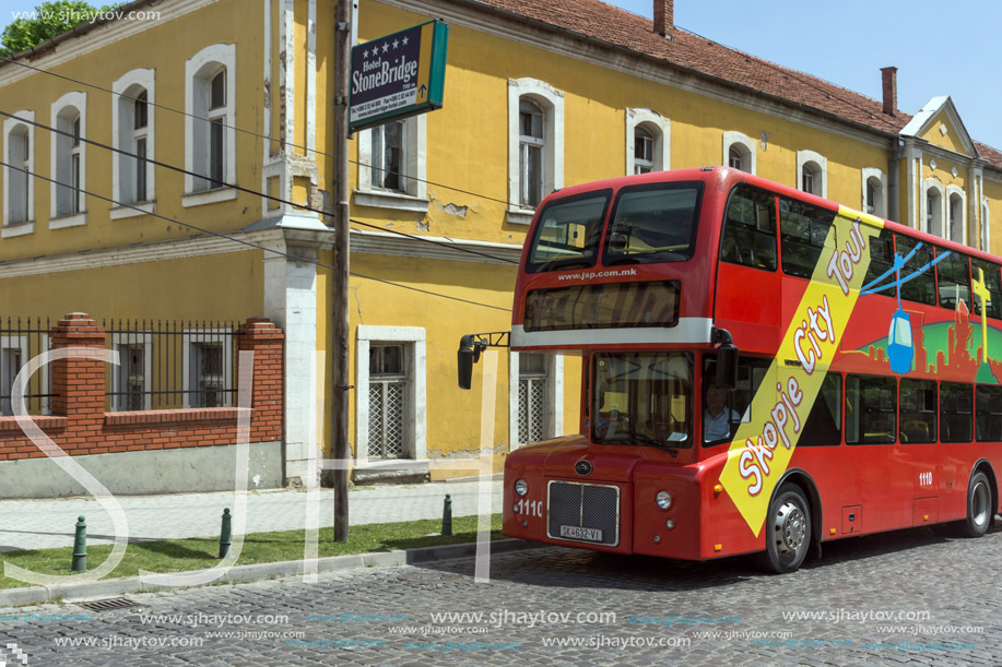 SKOPJE, REPUBLIC OF MACEDONIA - 13 MAY 2017:  A red double-decker bus passing through the streets of city of Skopje, Republic of Macedonia