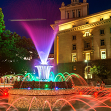 SOFIA, BULGARIA - JULY 21, 2017: Night photo of Fountain in front of The Building of the Presidency and Former Communist Party House in Sofia, Bulgaria