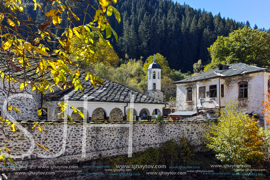 19th century Church of the Assumption, river and Autumn tree in town of Shiroka Laka, Smolyan Region, Bulgaria