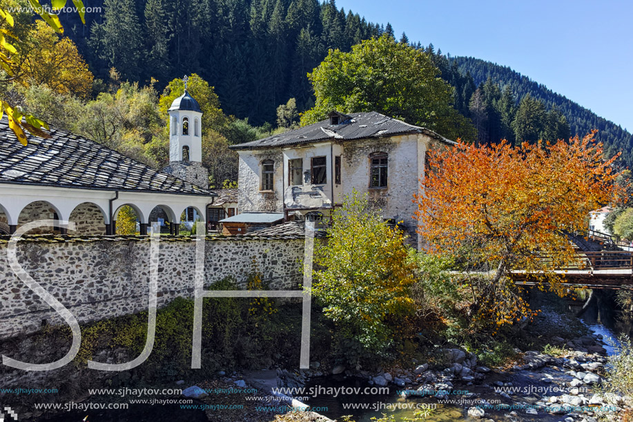 19th century Church of the Assumption, river and Autumn tree in town of Shiroka Laka, Smolyan Region, Bulgaria