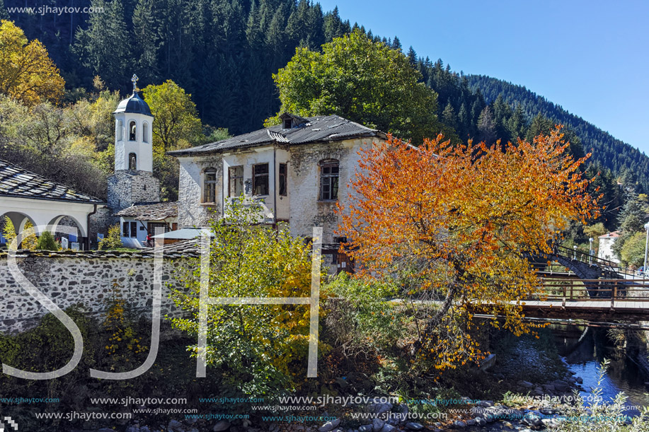 19th century Church of the Assumption, river and Autumn tree in town of Shiroka Laka, Smolyan Region, Bulgaria