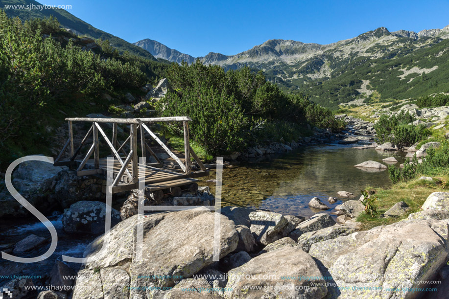 Wooden bridge over Mountain river and Banderishki Chukar peak, Pirin Mountain, Bulgaria