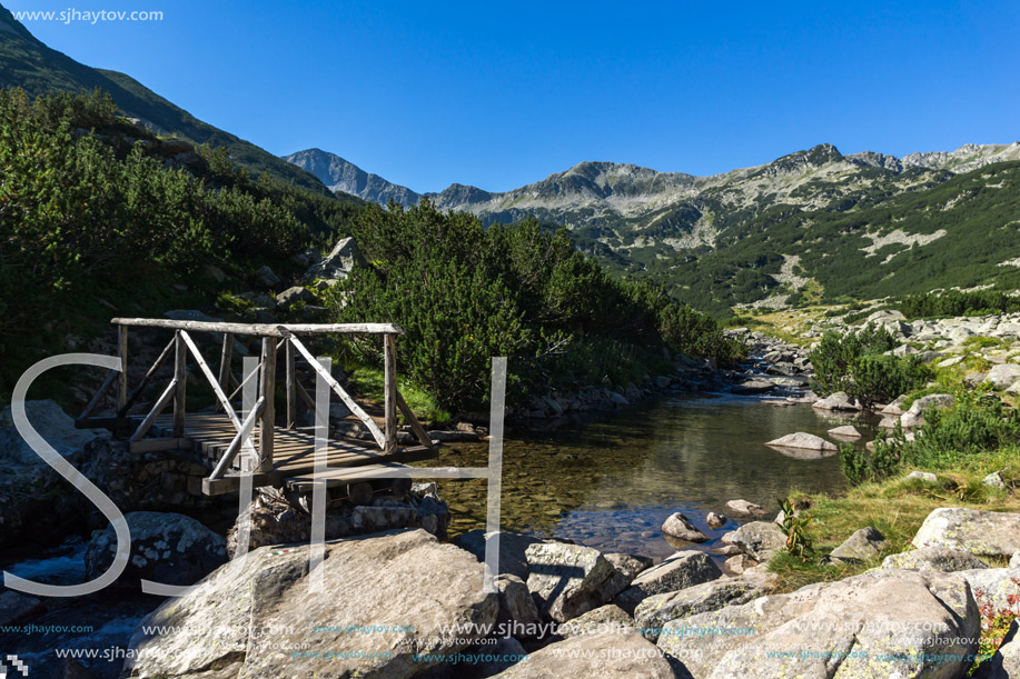 Wooden bridge over Mountain river and Banderishki Chukar peak, Pirin Mountain, Bulgaria