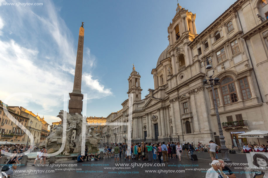 ROME, ITALY - JUNE 22, 2017: Tourists are strolling at the sunset in a Piazza Navona in city of Rome, Italy