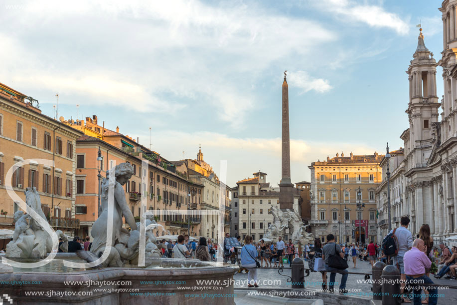 ROME, ITALY - JUNE 22, 2017: Tourists are strolling at the sunset in a Piazza Navona in city of Rome, Italy