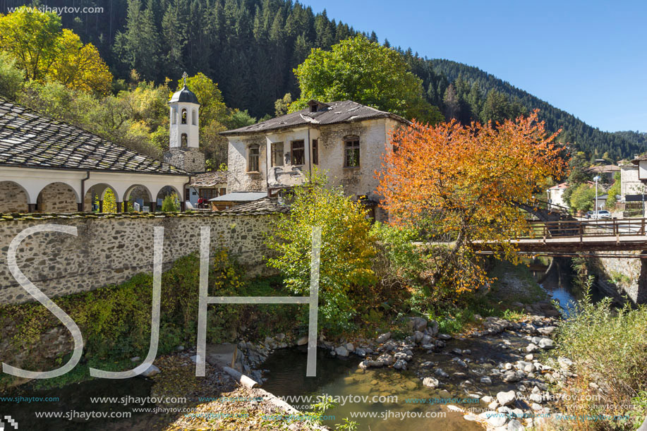 19th century Church of the Assumption, river and Autumn tree in town of Shiroka Laka, Smolyan Region, Bulgaria