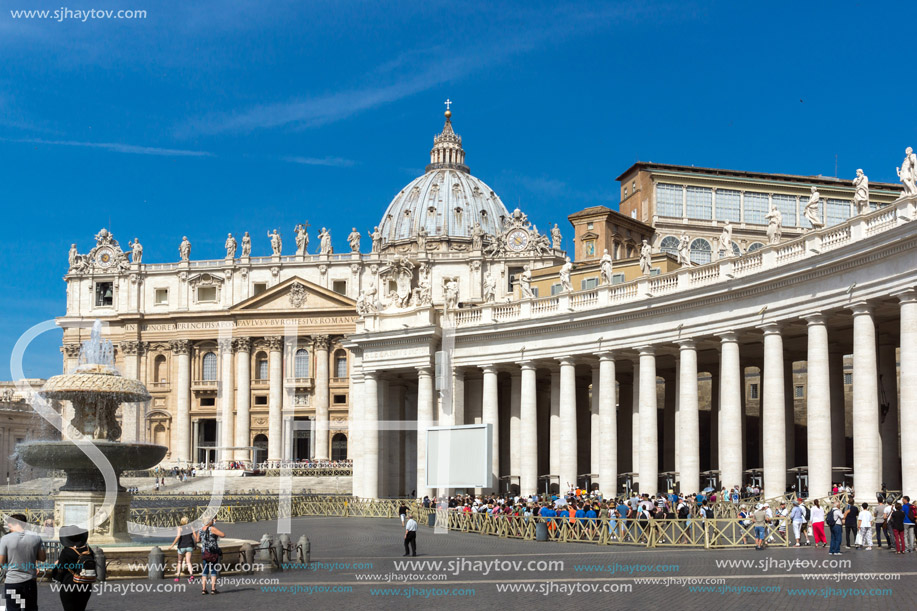 ROME, ITALY - JUNE 23, 2017: Tourists visit Saint Peter"s Square and St. Peter"s Basilica in Rome, Vatican, Italy