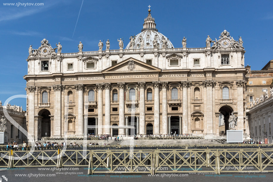 ROME, ITALY - JUNE 23, 2017: Tourists visit Saint Peter"s Square and St. Peter"s Basilica in Rome, Vatican, Italy