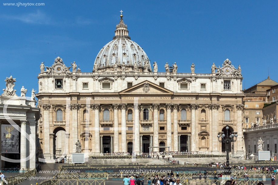 ROME, ITALY - JUNE 23, 2017: Tourists visit Saint Peter"s Square and St. Peter"s Basilica in Rome, Vatican, Italy