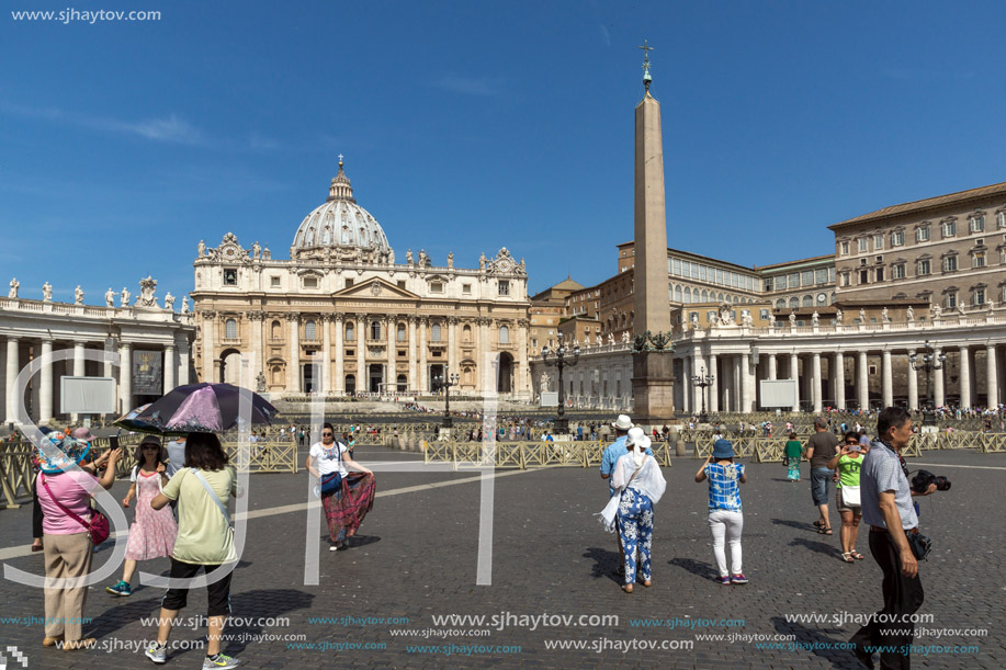 ROME, ITALY - JUNE 23, 2017: Tourists visit Saint Peter"s Square and St. Peter"s Basilica in Rome, Vatican, Italy