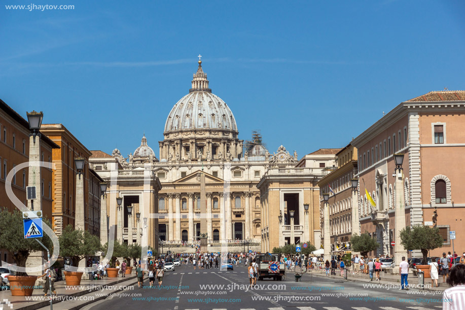 ROME, ITALY - JUNE 23, 2017: Tourists visit Saint Peter"s Square and St. Peter"s Basilica in Rome, Vatican, Italy