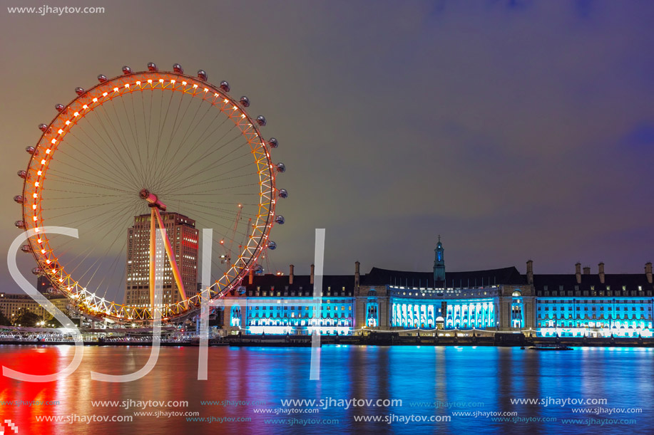 LONDON, ENGLAND - JUNE 16 2016: Night photo of The London Eye and County Hall from Westminster bridge, London, England, Great Britain