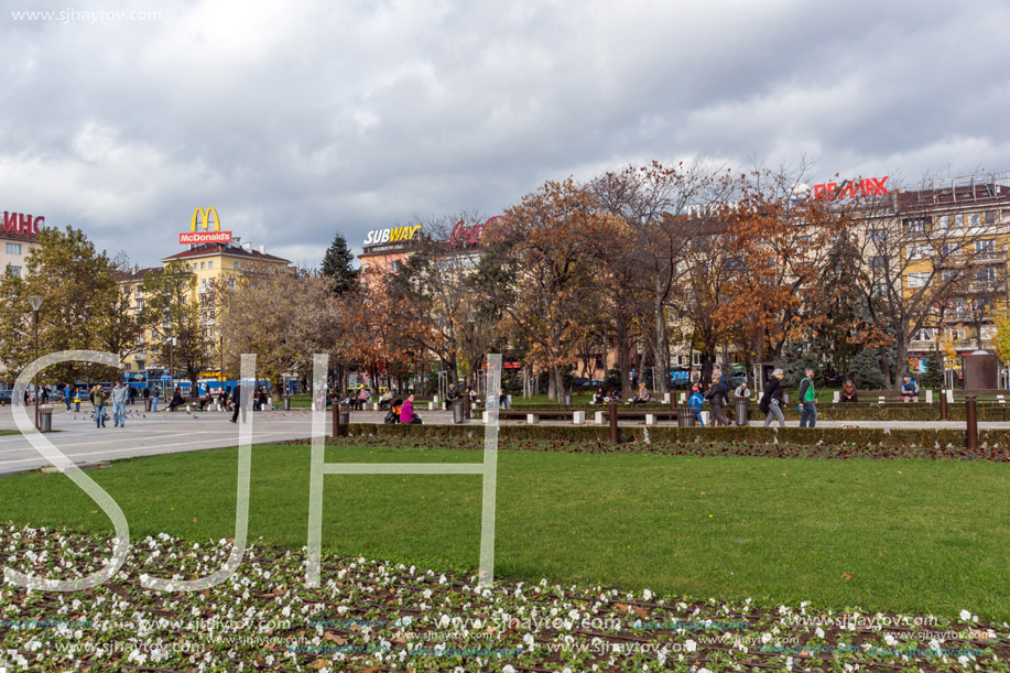 SOFIA, BULGARIA -NOVEMBER 12, 2017: Walking people on park in front of  National Palace of Culture in Sofia, Bulgaria