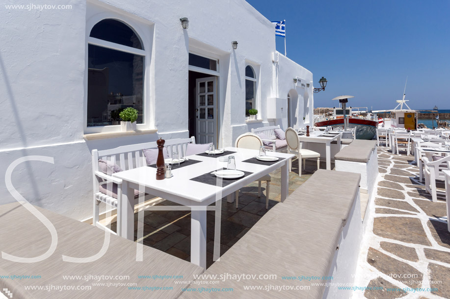 PAROS, GREECE - MAY 3, 2013: Old white house and Bay in Naoussa town, Paros island, Cyclades, Greece