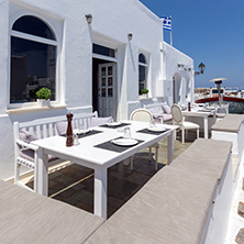 PAROS, GREECE - MAY 3, 2013: Old white house and Bay in Naoussa town, Paros island, Cyclades, Greece