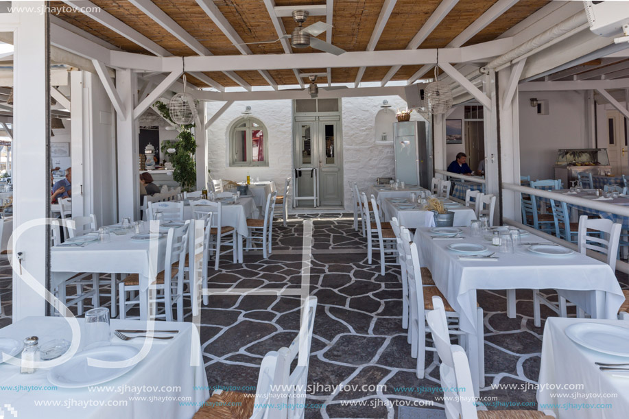 PAROS, GREECE - MAY 3, 2013: Old white house and Bay in Naoussa town, Paros island, Cyclades, Greece