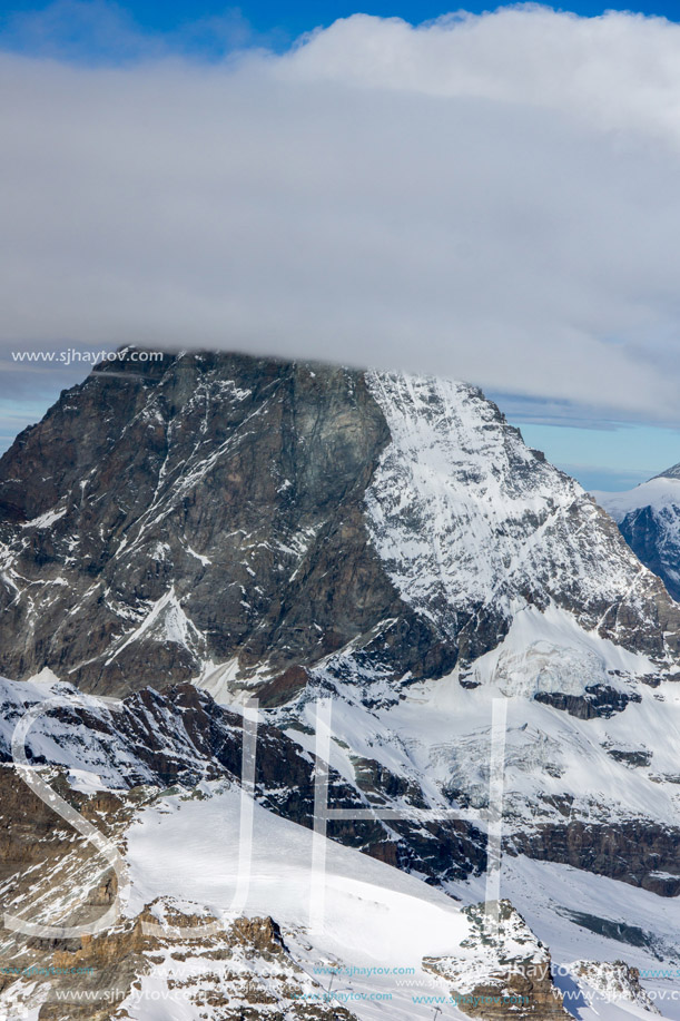 Winter panorama of mount Matterhorn covered with clouds, Canton of Valais, Alps, Switzerland