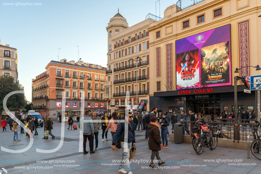 MADRID, SPAIN - JANUARY 22, 2018: Sunset view of walking people at Callao Square (Plaza del Callao) in City of Madrid, Spain
