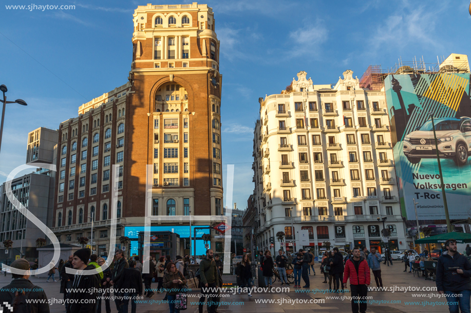 MADRID, SPAIN - JANUARY 22, 2018: Sunset view of walking people at Callao Square (Plaza del Callao) in City of Madrid, Spain