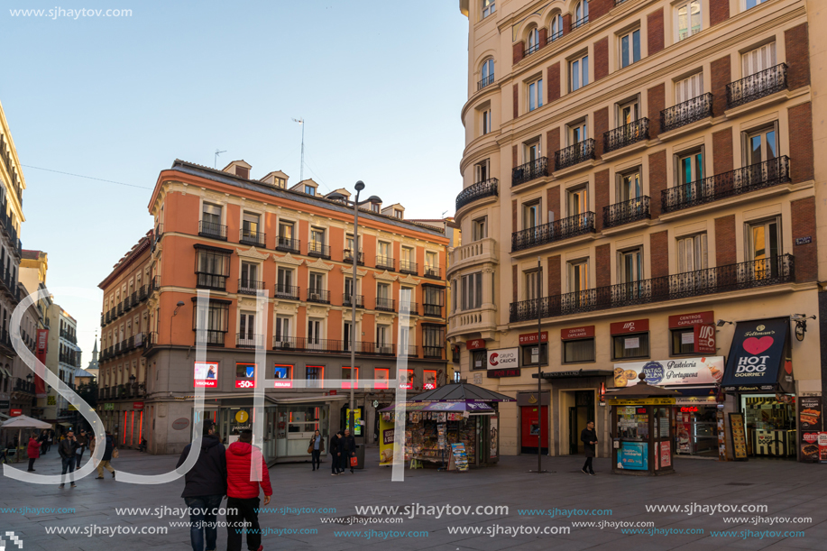 MADRID, SPAIN - JANUARY 22, 2018: Sunset view of walking people at Callao Square (Plaza del Callao) in City of Madrid, Spain