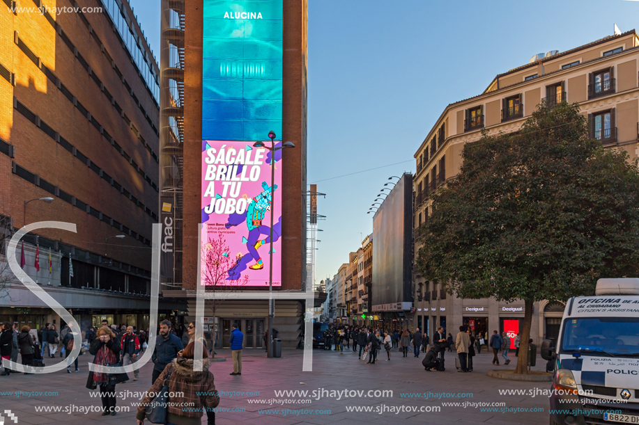 MADRID, SPAIN - JANUARY 22, 2018: Sunset view of walking people at Callao Square (Plaza del Callao) in City of Madrid, Spain
