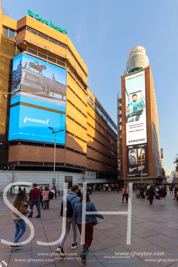 MADRID, SPAIN - JANUARY 22, 2018: Sunset view of walking people at Callao Square (Plaza del Callao) in City of Madrid, Spain