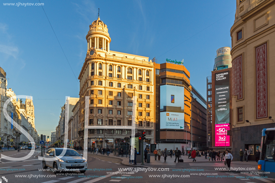 MADRID, SPAIN - JANUARY 22, 2018: Sunset view of walking people at Callao Square (Plaza del Callao) in City of Madrid, Spain