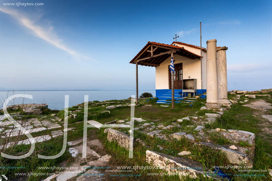 Amazing sunset of Orthodox church at coastline of Thassos town, East Macedonia and Thrace, Greece