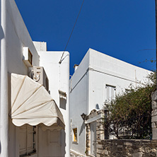 PAROS, GREECE - MAY 3, 2013: Typical street with white houses in town of Parakia, Paros island, Cyclades, Greece
