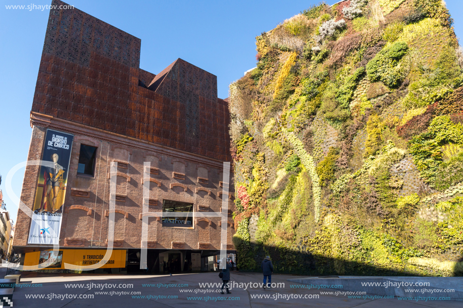 MADRID, SPAIN - JANUARY 22, 2018: Vertical garden wall and CaixaForum Museum in City of Madrid, Spain