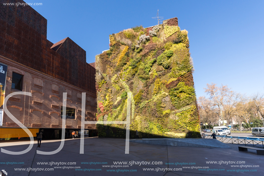 MADRID, SPAIN - JANUARY 22, 2018: Vertical garden wall and CaixaForum Museum in City of Madrid, Spain