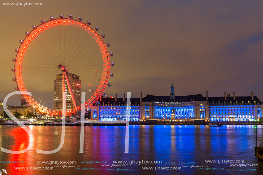 LONDON, ENGLAND - JUNE 16 2016: Night photo of The London Eye and County Hall from Westminster bridge, London, England, Great Britain