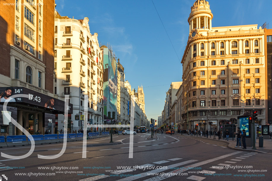 MADRID, SPAIN - JANUARY 22, 2018: Sunset view of walking people at Callao Square (Plaza del Callao) in City of Madrid, Spain