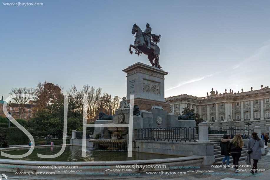 MADRID, SPAIN - JANUARY 22, 2018:  Sunset view of Monument to Felipe IV and the Royal Palace of Madrid, Spain